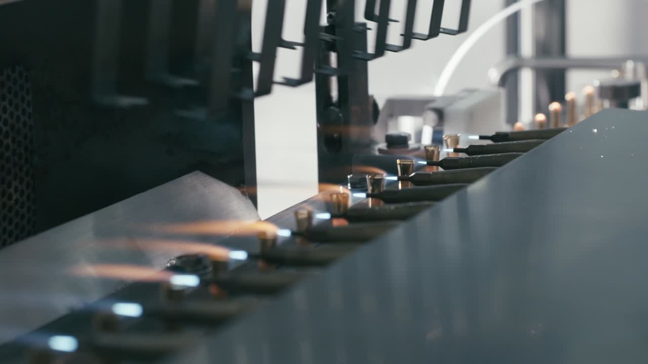 close view of machine that seals and separates the top from the bottom to facilitate proper fitting and assembly.