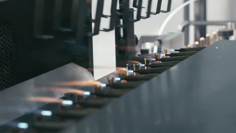 close view of machine that seals and separates the top from the bottom to facilitate proper fitting and assembly.
