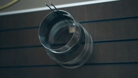 woman takes baking forms hanging on kitchen organizer