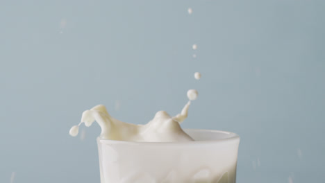 Video-of-glass-of-milk-with-copy-space-on-blue-background