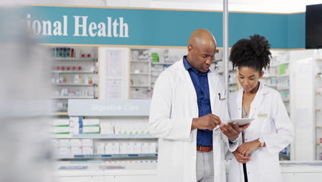 two pharmacists using a digital tablet together