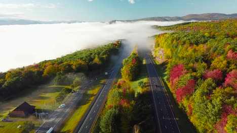 beautiful aerial over a highway through the fog in fall in new england 2