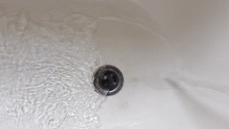 water draining into bathtub drain