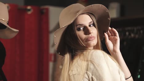 woman trying on hats in a boutique