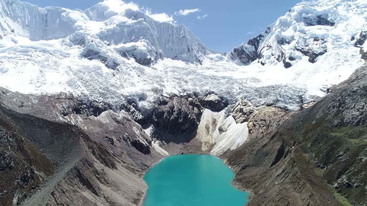 Majestic glacial lake with vibrant turquoise waters surrounded by rugged peaks and icy glaciers