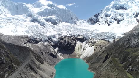 majestic glacial lake with vibrant turquoise waters surrounded by rugged peaks and icy glaciers