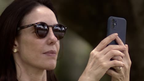 reflecting her use of technology in her sunglasses, slow motion