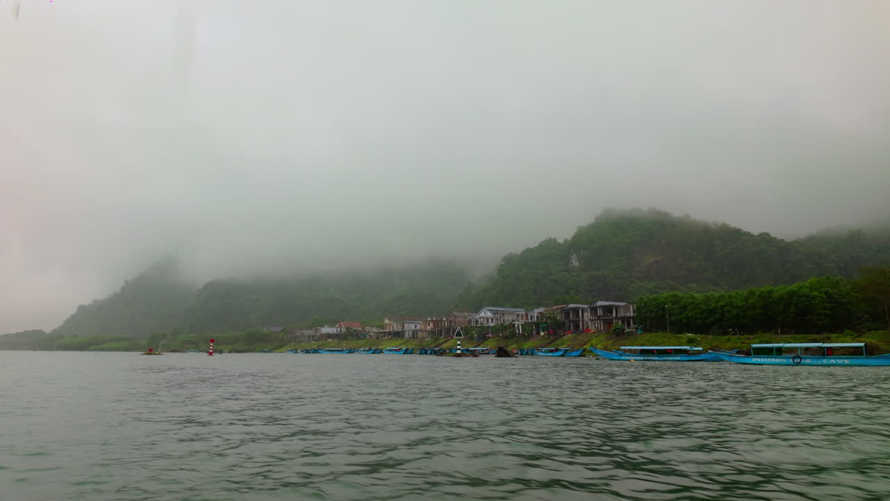 Misty Mountains Seen From The Boat Cruising In Phong Nha River In Vietnam. - POV shot