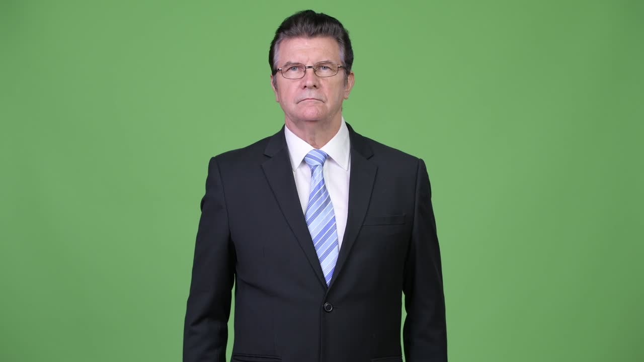 Senior handsome businessman pointing to camera