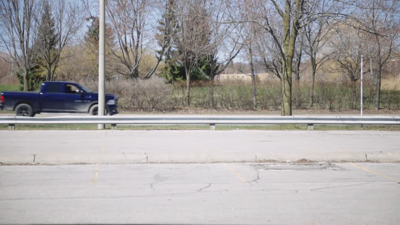 Cars Slowly Moving On The Road In Canada At Daytime - midshot