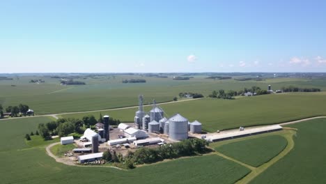 flying over grain bins on farm during summer