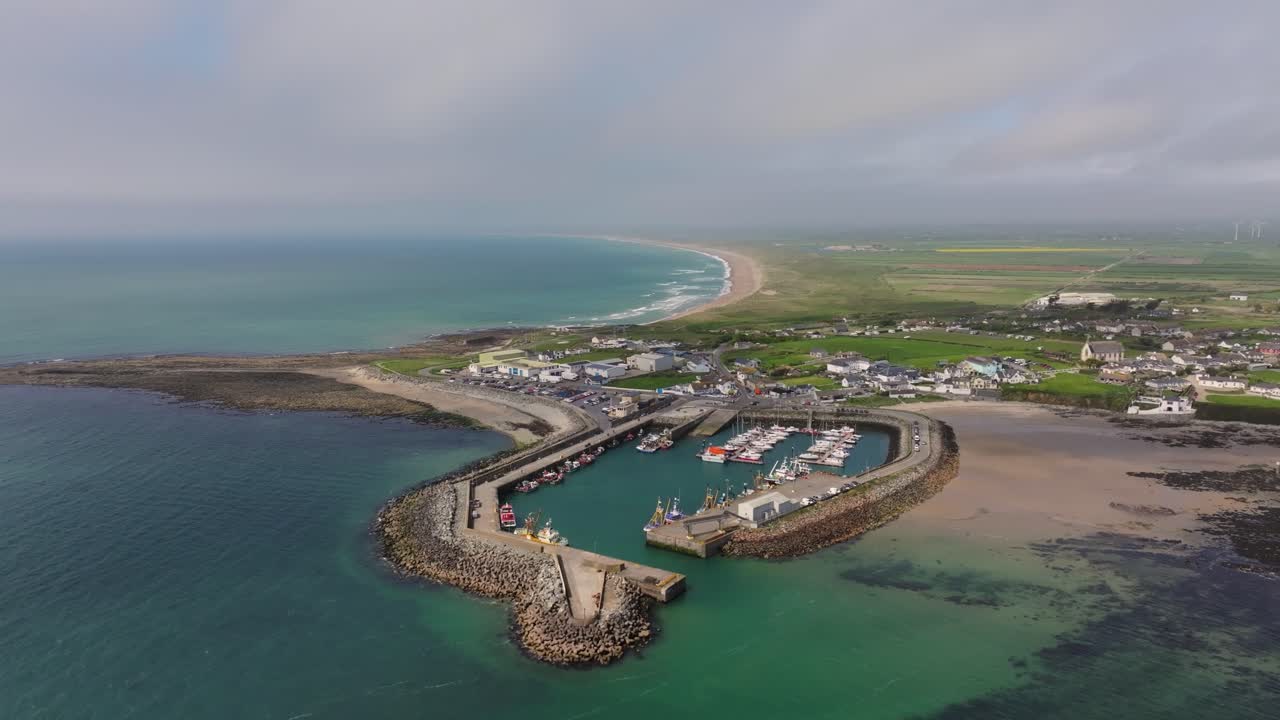 4K cinematic drone footage capturing Kilmore Quay, Co. Wexford, Ireland, on a bright day, showcasing the picturesque harbour, and colourful fishing boats Co.Wexford - Ireland_017