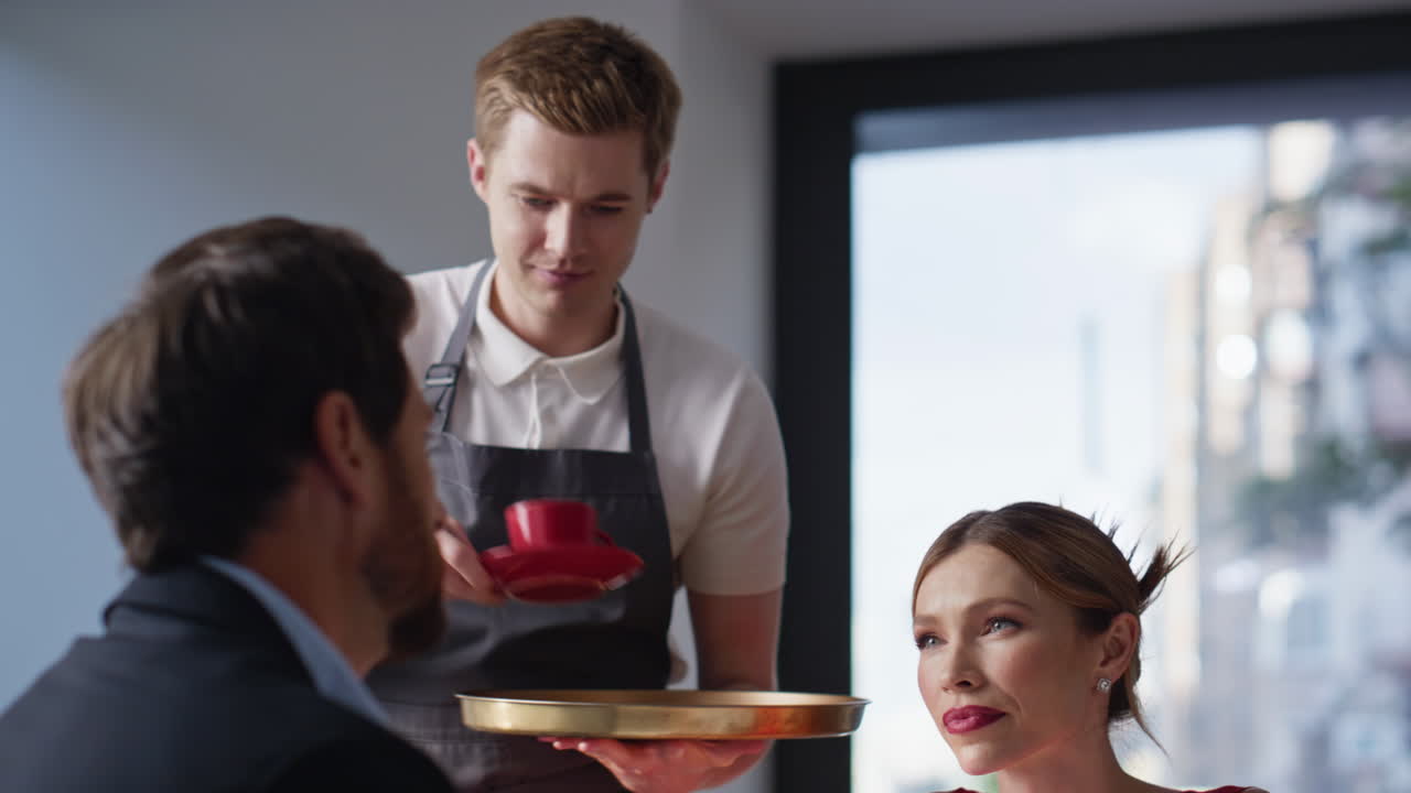Loving couple relaxing cafe looking with love closeup. Waiter serving table