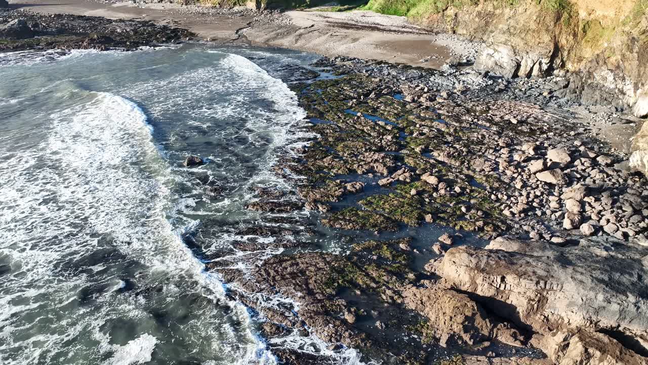 Irish Epic Coastline incoming tides and waves over rocks as Boatstrand Copper Coast Waterford before a winter storm