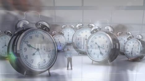 animation of businessman looking at alarm clocks over time-lapse of people walking against city