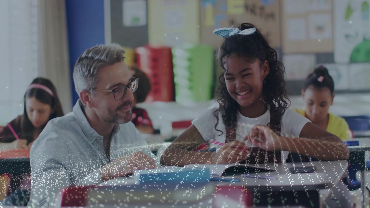 Teacher leaning over desk and pointing at workbook problem, girl writing with pencil for education