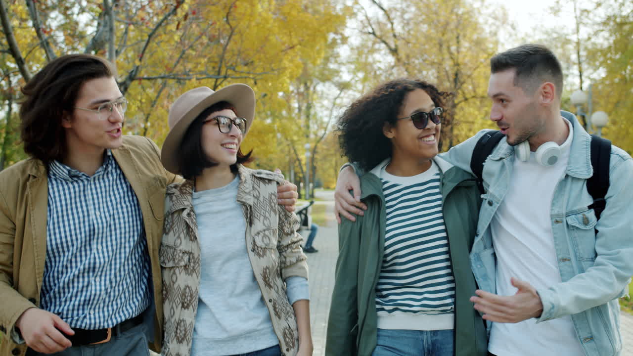 Friends Walking in Autumn Park