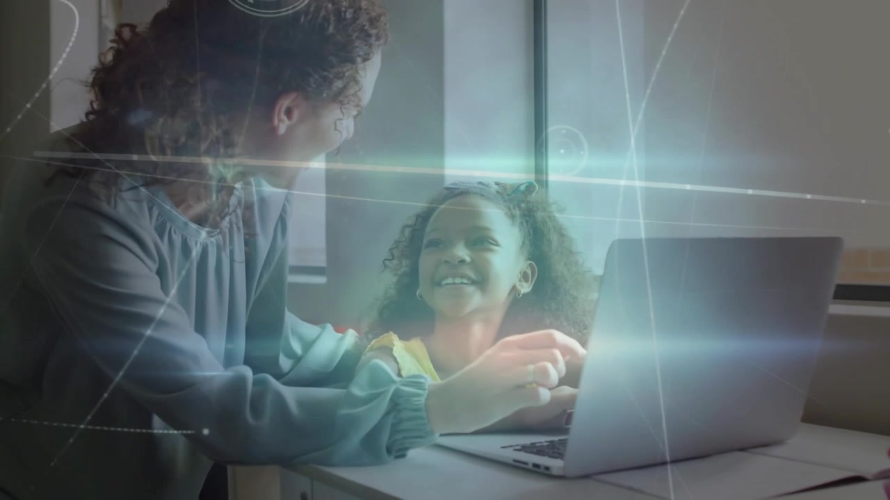 Woman powering up laptop and guiding daughter's typing in home education, adjusting hand placements
