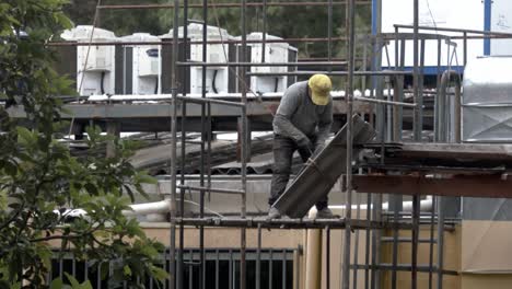 construction worker repairing a roof