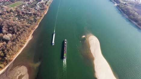 aerial view of a transport cargo industrial ship on a river in europe