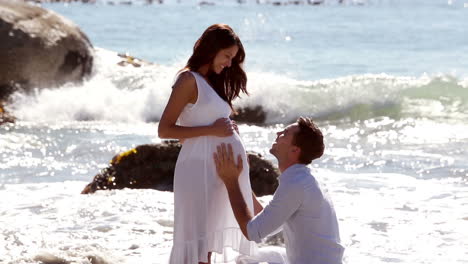 man holding the belly of her pregnant wife