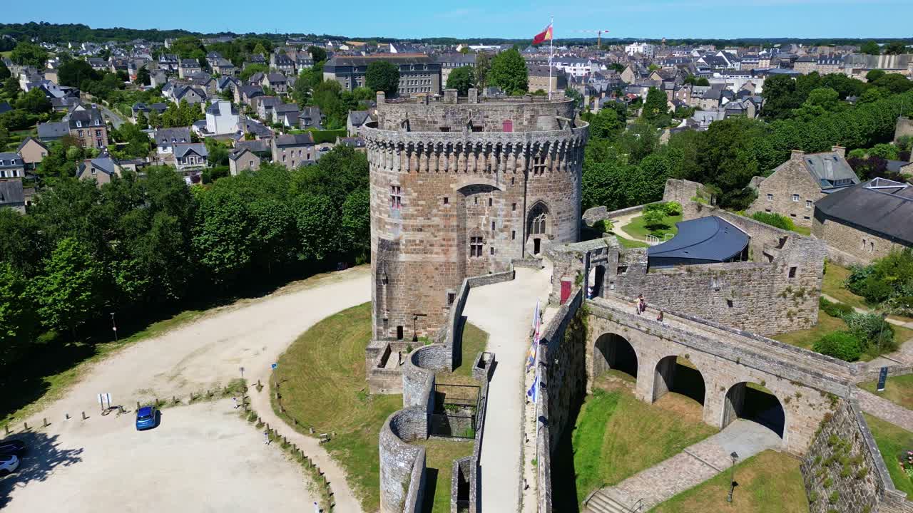 Dinan Castle with its tower, Côtes-d'Armor, France. Aerial drone backward ascending and tilt down