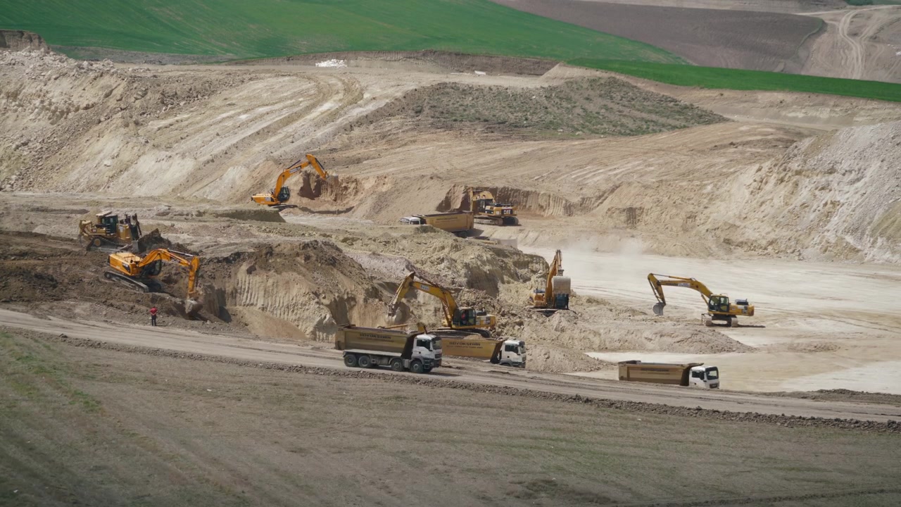 Heavy Machinery Operating at a Large Open Pit Construction Site