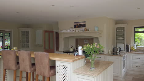 right to left pan of a large contemporary kitchen in a family home