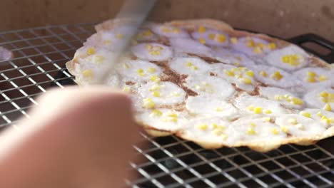 famous kanom krok thai street food desert, custardy sweet and salty coconut cream with corn filling topping