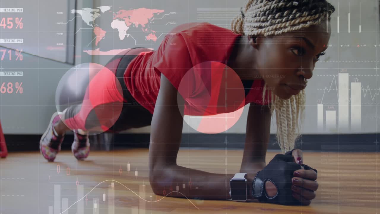 Animation of graphs over african american woman exercising at gym, doing plank