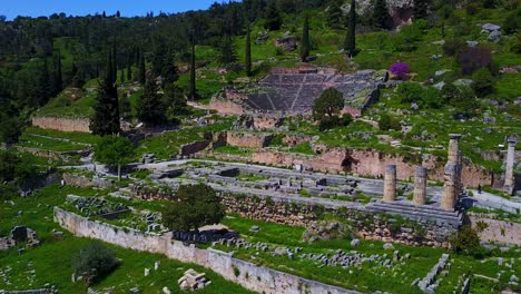 Apollo-Temple-in-Delphi-with-a-stunning-aerial-reveal-by-a-smooth-dolly-shot-pulling-out-shot,-Greece