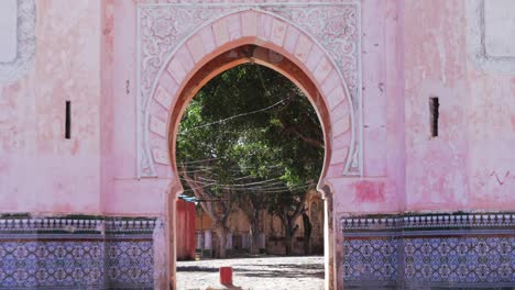 nador , morocco: arched, exterior door to mosque surrounded by colorful mosaic tiles