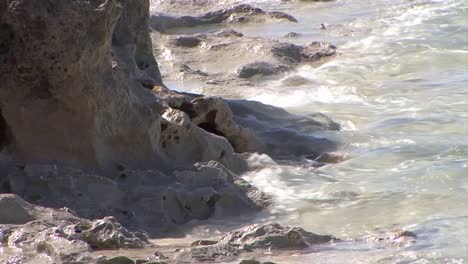 Small-waves-hitting-the-limestone-shore-of-Grand-Turk-Island,-Turks-and-Caicos-Islands