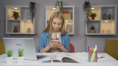 Female-student-using-phone-while-dancing.