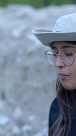 close-up portrait of a woman wearing a hat and glasses