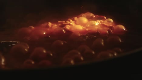 bubbling tomato sauce illuminated by a streak of light