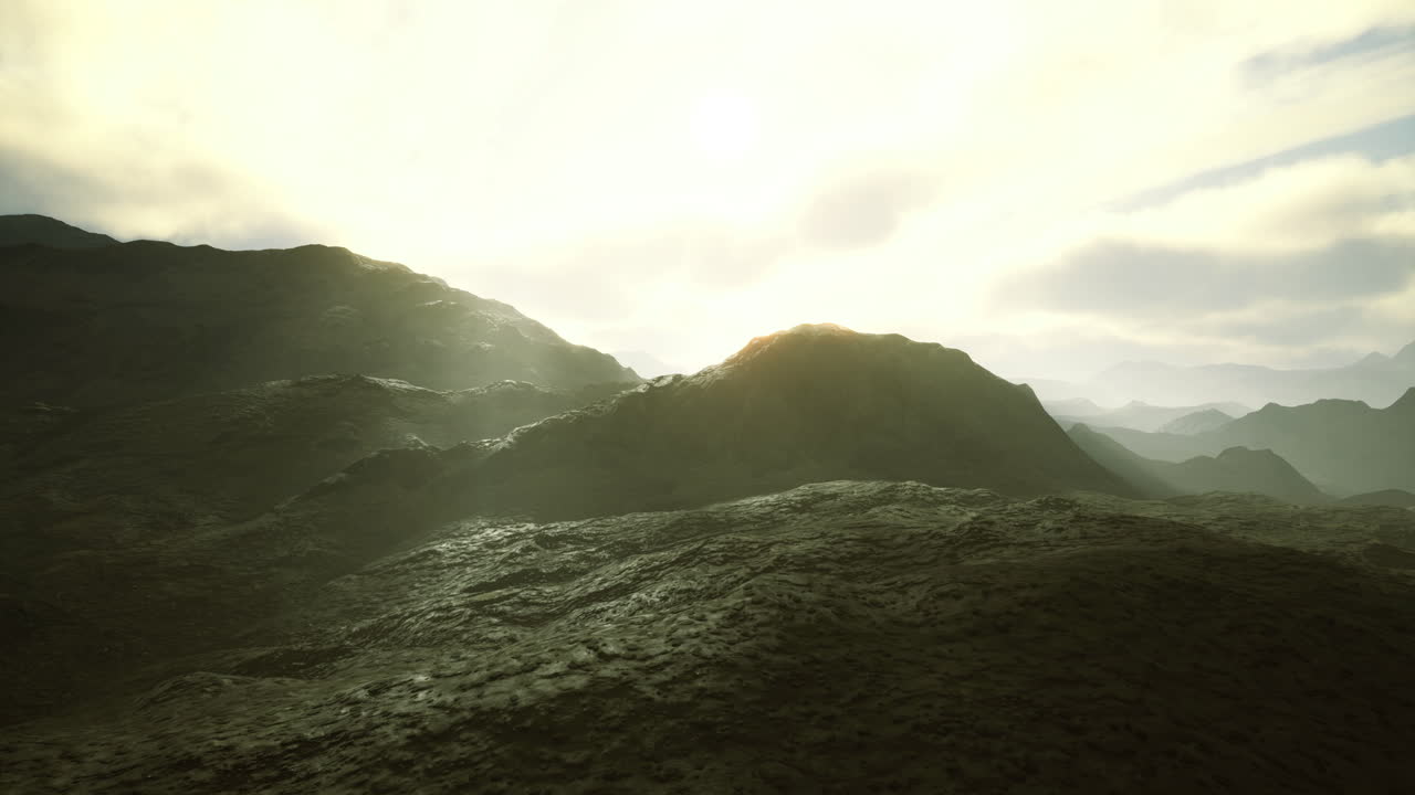 Sunset casting golden light over rugged mountain landscape in serene setting