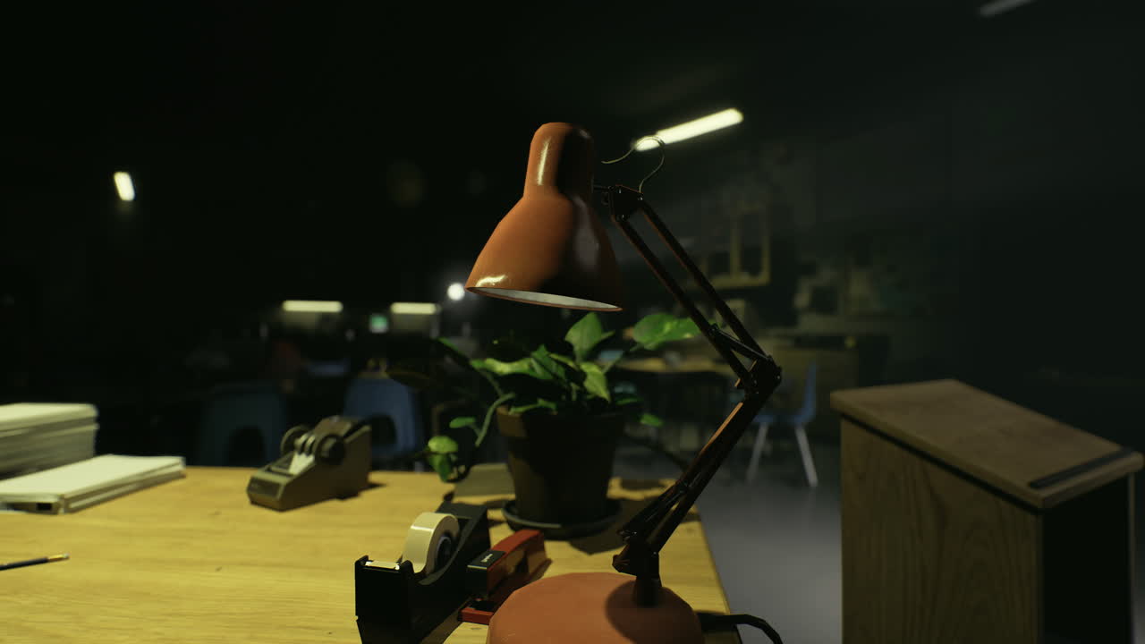 Desk with lamp and plant in a dimly lit classroom during the evening