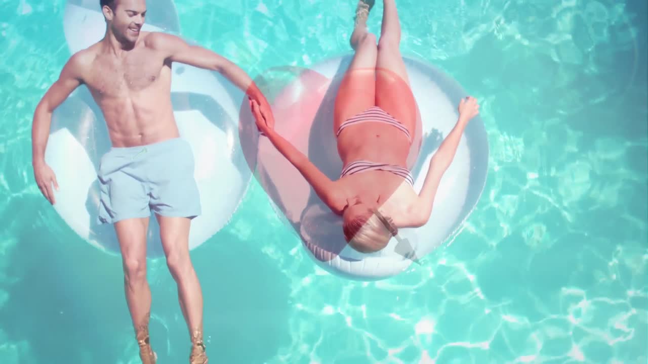 Couple lying on float in pool