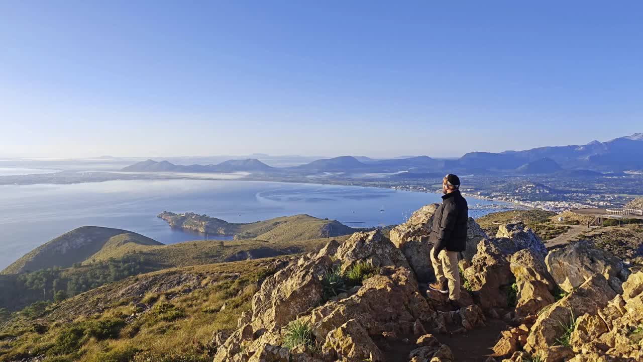Man looking at the views of the Bay of Pollensa from the Tramuntana mountain range