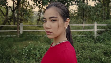 young woman in a red shirt outdoors