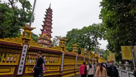 tourists walking around a historic pagoda