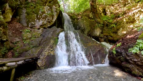 fairy waterfall at wild forest. wonderful fresh water waterfalls river flowing. forest rocks with a roaring stream running. panoramic sun landscape of nature waterfall. fresh nature. loop video. 4k