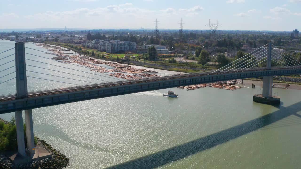 Aerial View Of North Arm Canada Line Skytrain Bridge Over The Fraser River Between Richmond And Vancouver In Canada - drone shot