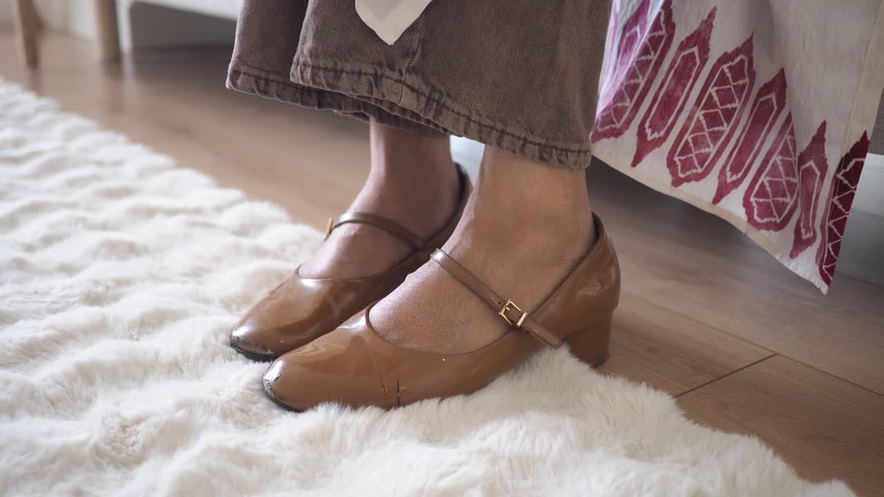 Close up of mary jane shoes on a carpet