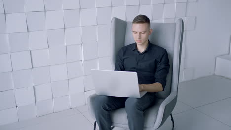 man working on laptop in modern office