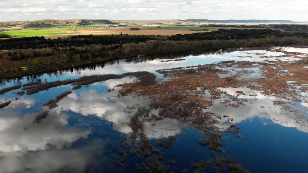 Aerial panning landscape view of the Wisconsin river with amazing clouds in the reflection of the water