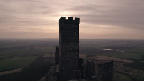 Medieval-Hazmburk-Castle-ruin-on-hilltop-high-above-village,-drone-aerial-view