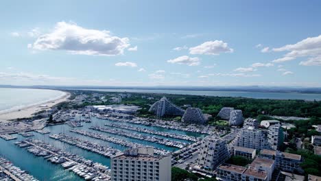 Aerial-flight-over-marina-of-La-grande-motte-and-famous-Pyramide-Architecture-in-background