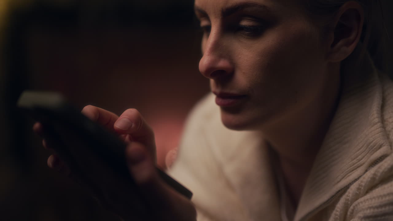 Portrait of Woman Shopping Online on Smartphone at Night